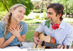 man-with-a-rose-in-his-mouth-playing-the-guitar-for-his-girlfriend-cffj1h.jpg