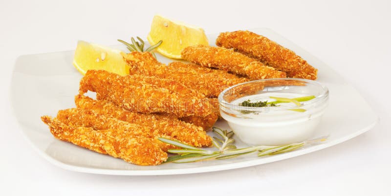 Chicken fingers. Plate of crispy chicken fingers and dip on white background stock photo